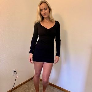 Black tight fitting long sleeved dress.